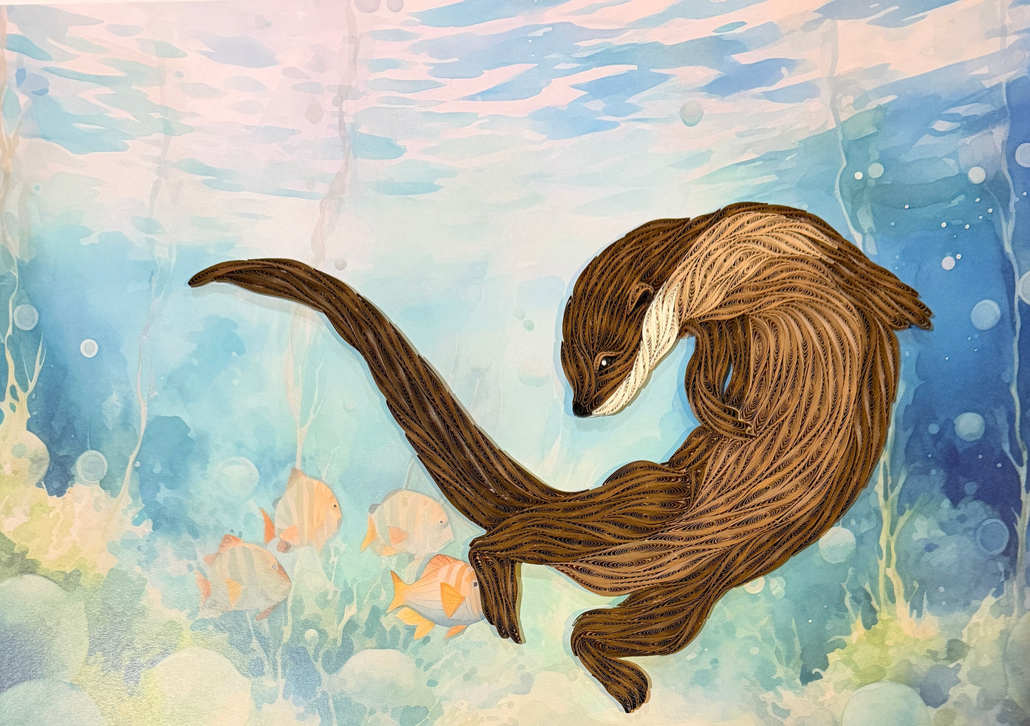 Watercolor-style artwork of an otter swimming underwater, with blue and turquoise water, soft pink light near the surface, and small orange fish in the background.